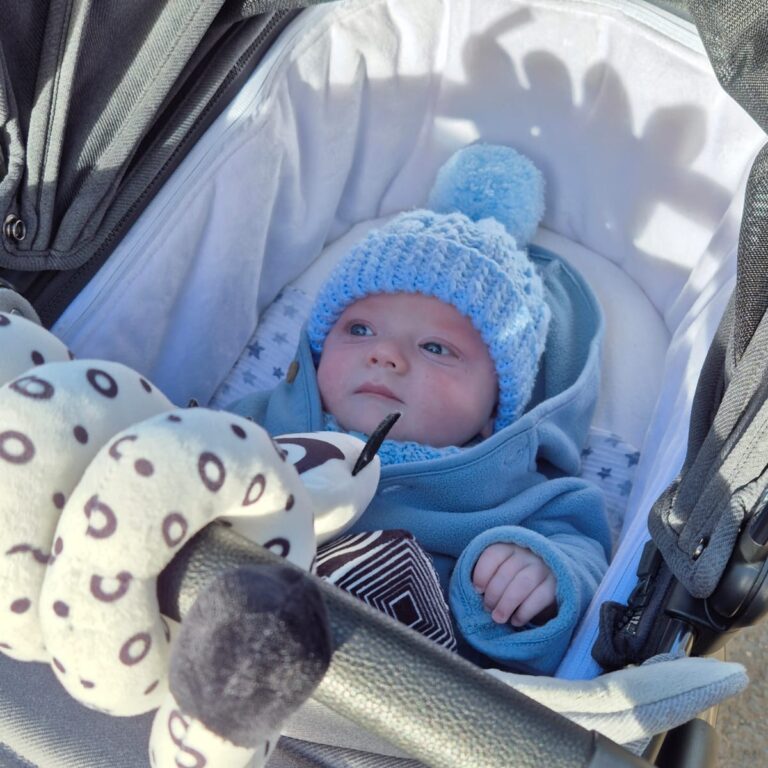 Small child wrapped up in a pram